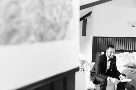 Black and white photograph of groom reading over his speech in the morning before wedding at Achnagairn Estate