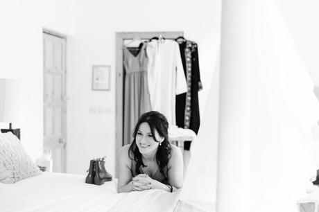 Black and white photograph of bridesmaid laying on the bed at a Achnagairn Estate wedding