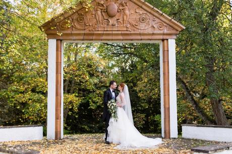 Bride & groom under folly at Achnagairn Estate