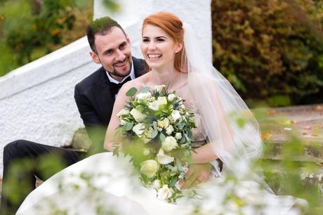 Redheaded bride laughing on the steps at Achnagairn Estate