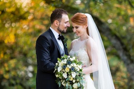 Bride & groom laugh and smile in autumn wedding photograph