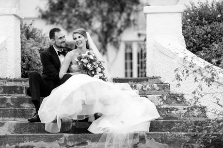 Couple laughing together on the steps in Wedding Photography at Achnagairn Estate 