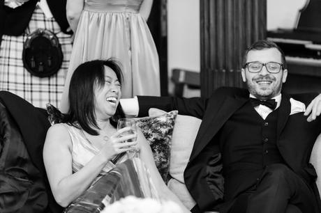 Black and white photograph of wedding guests having fun. 