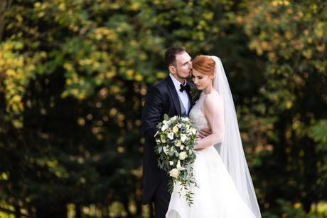 Groom kisses forehead of redheaded bride at Achnagairn Estate