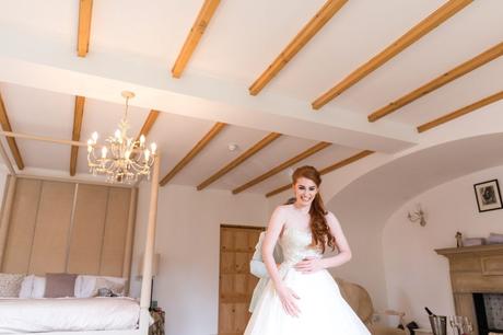 Redheaded bride being laced into wedding dress at Achnagairn Estate wedding