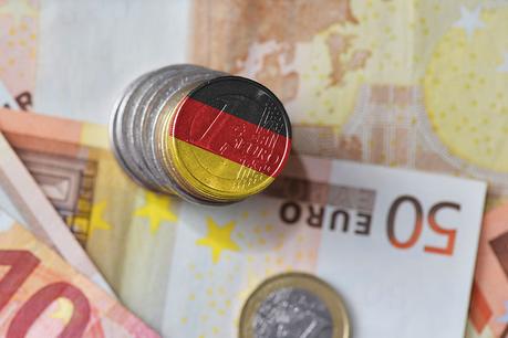 euro coin with national flag of germany on the euro money banknotes background. finance concept