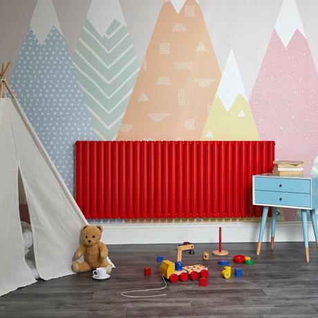 horizontal red radiator in a playroom