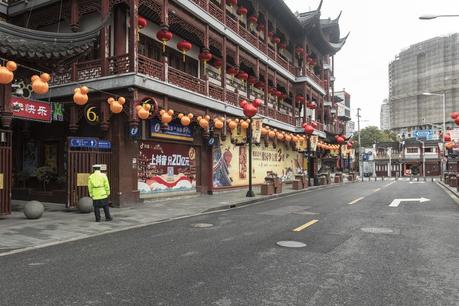 A security guard stands outside the empty Yuyuan Bazaar in Shanghai, Feb. 7.
