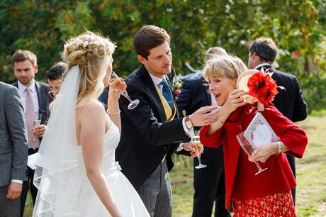 the groom lends a hand at a suffolk marquee wedding