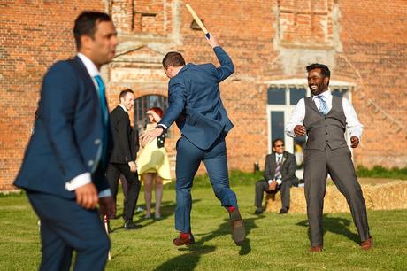 wedding guests playing rounders at a godwick barn wedding