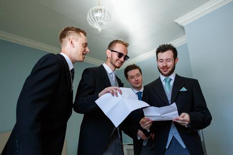 groomsmen look through their duties for the day