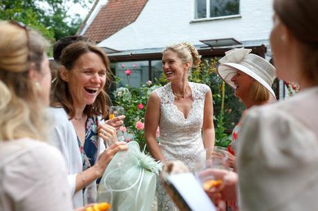 the bride laughs with her friends at her norfolk wedding