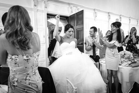 a bride making an entrance to the dining room at hengrave hall