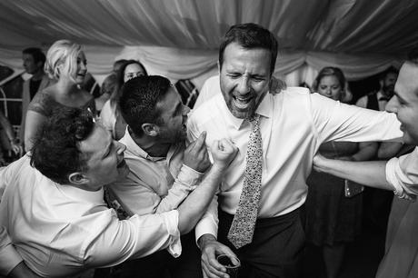 a groom dances with his guests