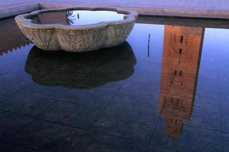 12th century Koutoubia minaret (70m) reflected in a fountain.