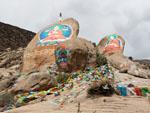 Colourful rock murals of Buddha with protector