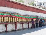 Tibetans turning prayer wheels at Drepung Monastery