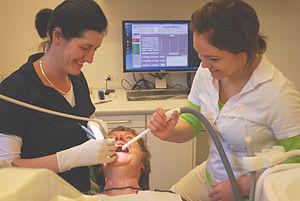 English: A Dentist and her Dental assistant