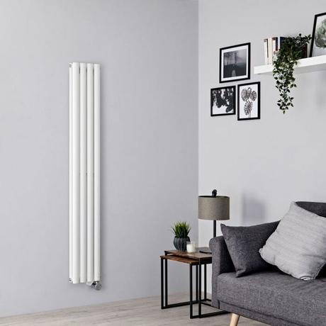 white vertical electric radiator in a gray living room