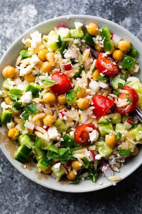 overhead view of orzo pasta salad in gray bowl