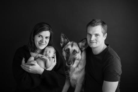 Newborn family photos with siblings and dogs.