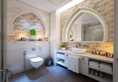 A really nicely decorated bathroom with a lot of lights and earthy tones.