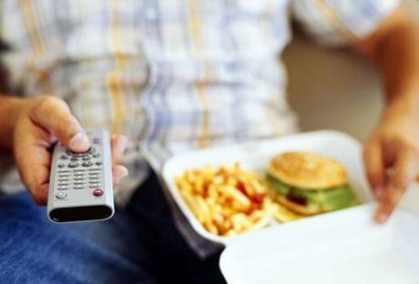 Type 2 Diabetes latest #Type2Diabetes Photo of man watching TV, eating junk food.