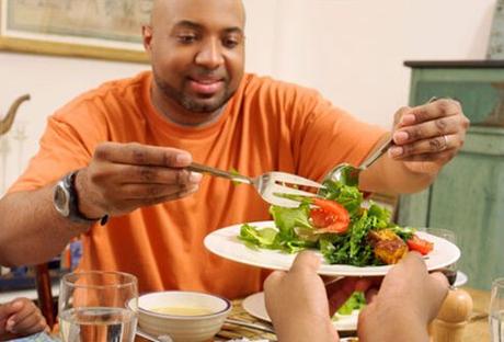 Type 2 Diabetes latest #Type2Diabetes Photo of a man serving salad, managing his diabetes.