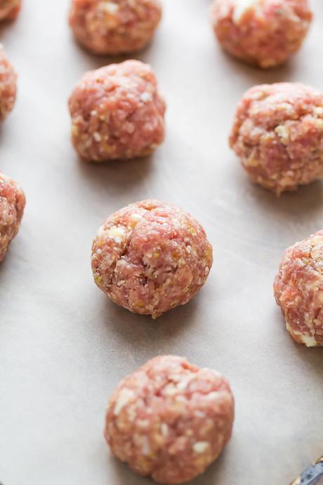 raw ground turkey meatballs on baking sheet