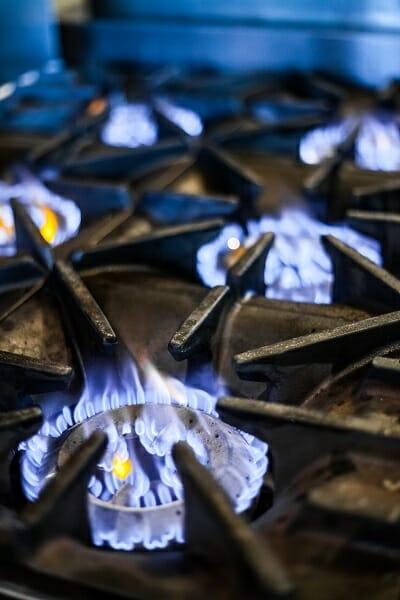 A close up of the top of a gas cooking stove