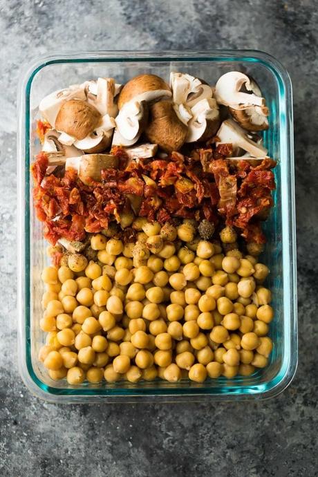 larger glass meal prep container filled with chickpea pasta ingredients
