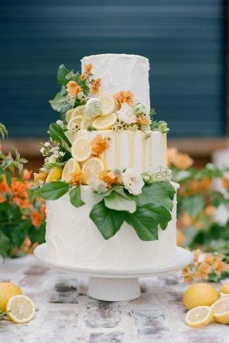 buttercream wedding cakes three tiered white with lemons leaves and drip dana fernandez photography