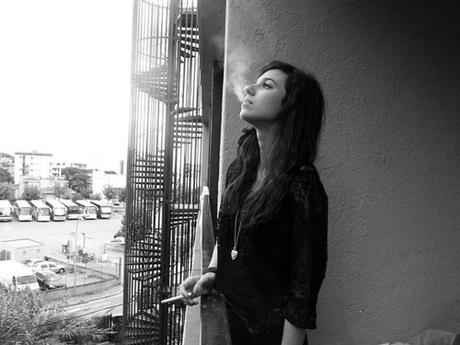 smoking cigarette at the balcony