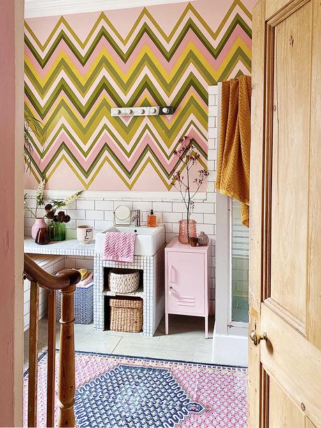 Pink bathroom decor with colourful zig zag wall mural