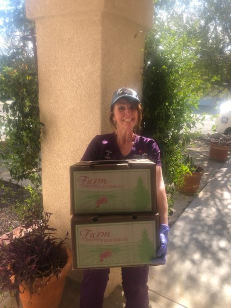 Cindy Kelly with fresh produce boxes 