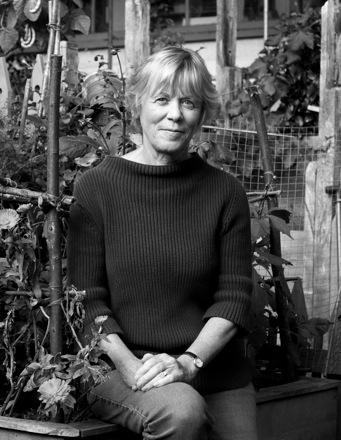 black and white photo of stephanie donaldson sat on a wall