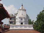 Temple to Kam Dev, a companion of Shiva, with a tall corncob like spire