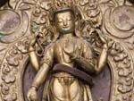 Intricate brass Buddha relief near Seto Machhendranath Temple