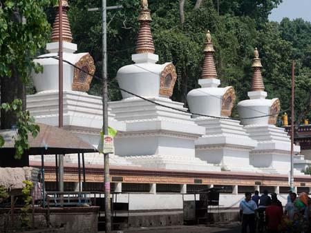 Smaller stupas at the base of the hill leading up to the temple