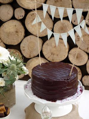 A Dessert Table with Beautiful Natural Earthy Tones and fantastic wooden log backdrop By That Cute Little Cake