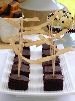 A Dessert Table with Beautiful Natural Earthy Tones and fantastic wooden log backdrop By That Cute Little Cake