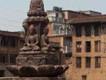 Stone Buddha statues with residential buildings in the background