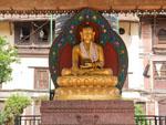 Gold Buddha statue sitting in the courtyard