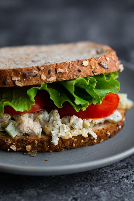 close up view of chickpea salad sandwich on plate