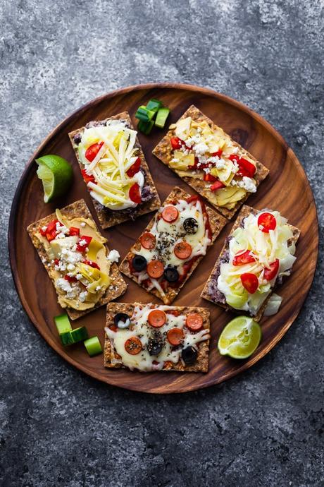 open-faced sandwiches on wooden platter