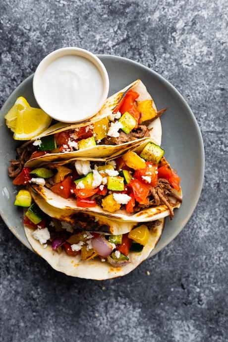 overhead shot of honey garlic shredded beef tacos on plate