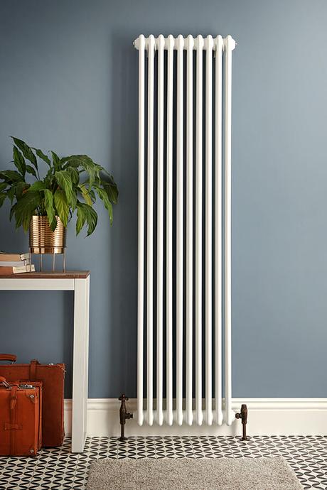 a tall white milano windsor radiator on a blue background