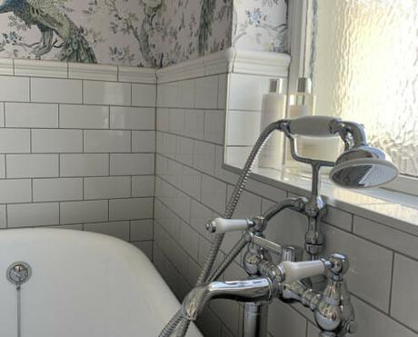 a traditional bath tap next to a bath