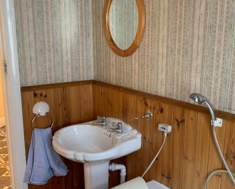 an old basin in a wooden bathroom