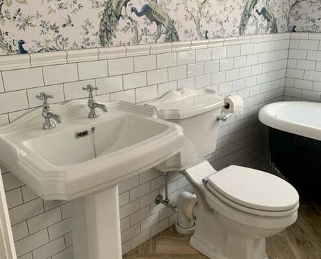 a basin and toilet in a traditional bathroom